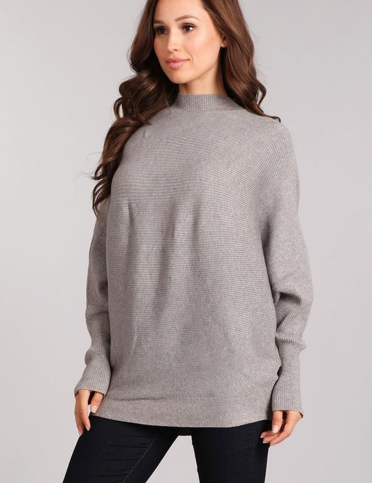 Woman modeling the Celeste Cozy Pullover, a gray rib-knit pullover with dolman sleeves and mock neck.