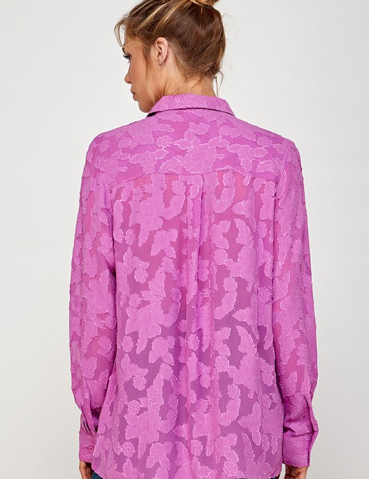 Back view of a woman wearing a lightweight, pink Luna Mesh Blouse with a modern floral pattern.