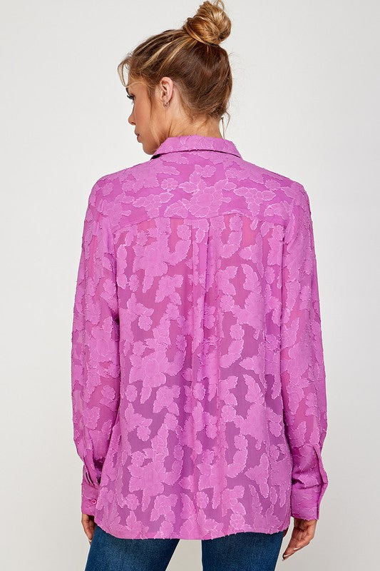 Back view of a woman wearing a lightweight, pink Luna Mesh Blouse with a modern floral pattern.