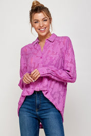 Model wearing a pink Luna Mesh Blouse with button-down design and casual jeans, showcasing modern elegance.