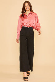 Woman wearing Renley Wide Leg Jean with a pink blouse, showcasing high-rise wide-leg cut and cropped length for a stylish look.