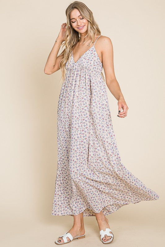 Woman in a floral maxi dress featuring a flowing design, perfect for garden parties and casual outings.