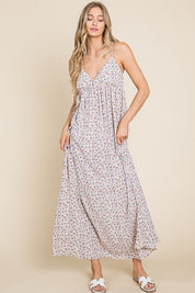 Model wearing a Valencia Floral Dress, a sleeveless maxi dress with a charming floral print.