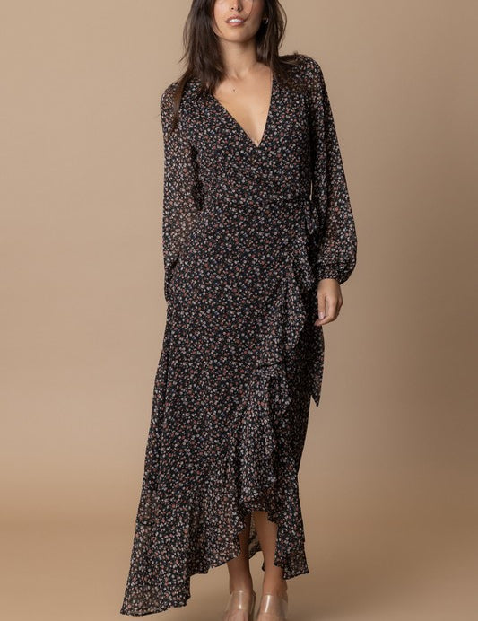 Woman wearing the Echo Floral Wrap Dress, featuring a floral print, wrap design, and flowing silhouette.