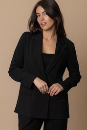 Piper Classic Blazer in black, featuring a classic collared silhouette and front pockets, perfect for any occasion.