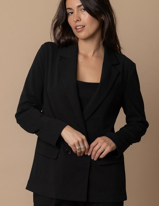 Woman wearing the Piper Classic Blazer in black, a sophisticated and versatile piece for any wardrobe.