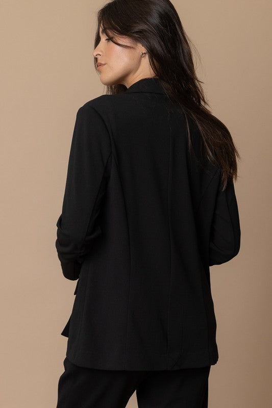 Back view of a woman wearing the Piper Classic Blazer, showcasing its elegant design and versatile silhouette.