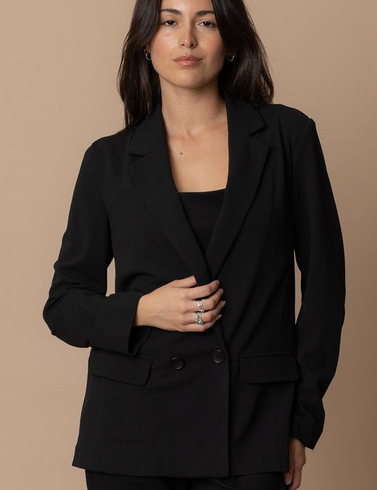 Piper Classic Blazer in black worn by a model, featuring a classic collared silhouette and double-button closure.