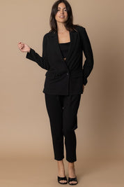 Model wearing the Piper Classic Blazer in black, styled with tailored trousers and heels against a neutral background.