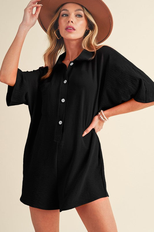 Hannah Half Button RomperThe Hannah Half Button Romper is the perfect blend of comfort and style for your warm-weather wardrobe! This versatile romper features a loose, easy fit with a half-button front and a classic turn-down collar, making it a chic cho