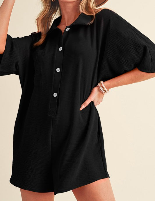 Hannah Half Button RomperThe Hannah Half Button Romper is the perfect blend of comfort and style for your warm-weather wardrobe! This versatile romper features a loose, easy fit with a half-button front and a classic turn-down collar, making it a chic cho