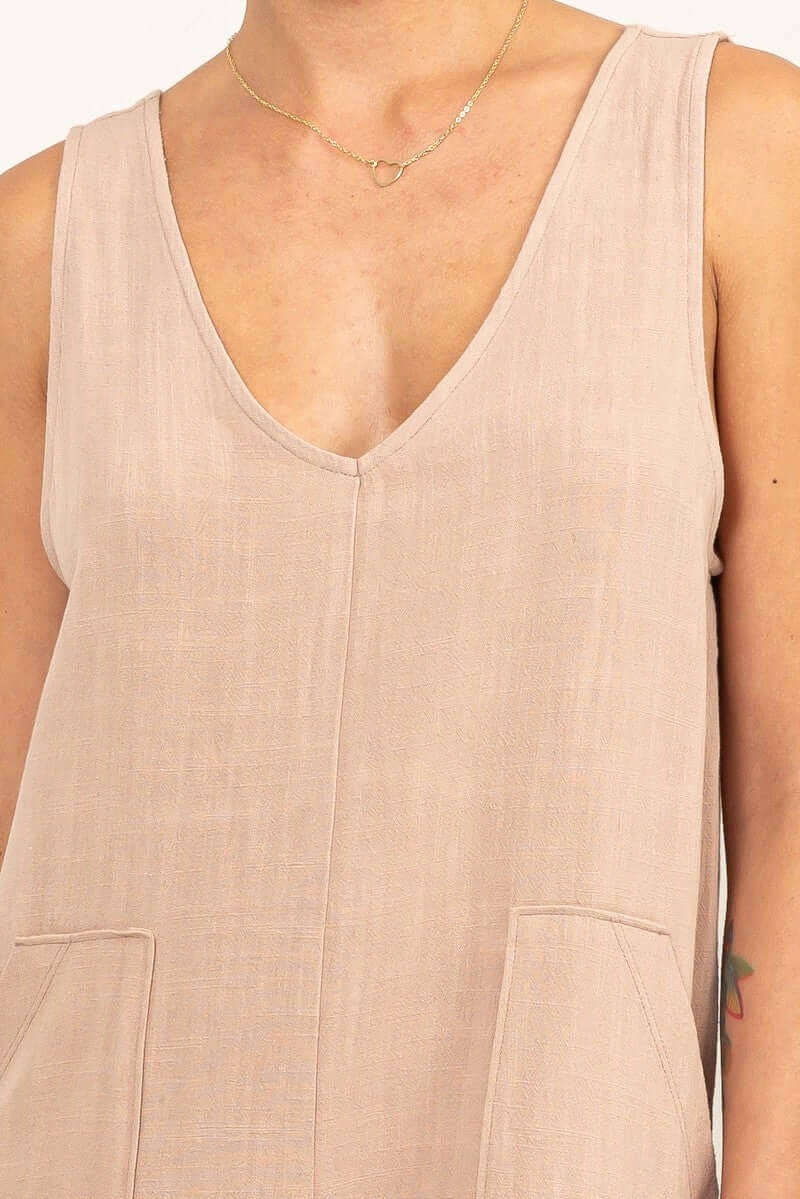 Jasmine Joy JumpsuitCrafted from a linen fabric blend, the Jasmine Joy Jumpsuit is extremely flattering and features a deep V-neck. The relaxed bodice tops a pair of breezy shorts, creating a timeless piece perfect for any occasion. Pair it with sandals a