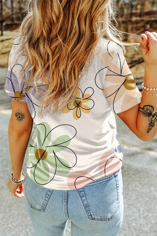 Sophia Summer Floral TeeElevate your summer wardrobe with the Sophia Summer Floral Tee, a stylish essential adorned with a vibrant flower print. Crafted from a soft and breathable fabric blend, this tee ensures all-day comfort and effortless style. The ca