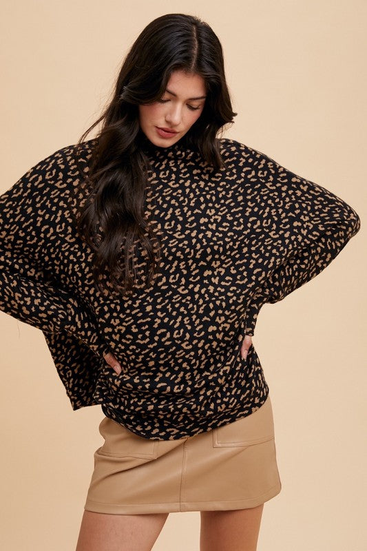 Woman wearing Kaida Leopard Sweater with animal jacquard knit and mock neck, styled with a beige skirt.