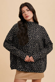 Woman wearing Kaida Leopard Sweater with animal jacquard knit, mock-neck, and relaxed fit for a chic, versatile look.