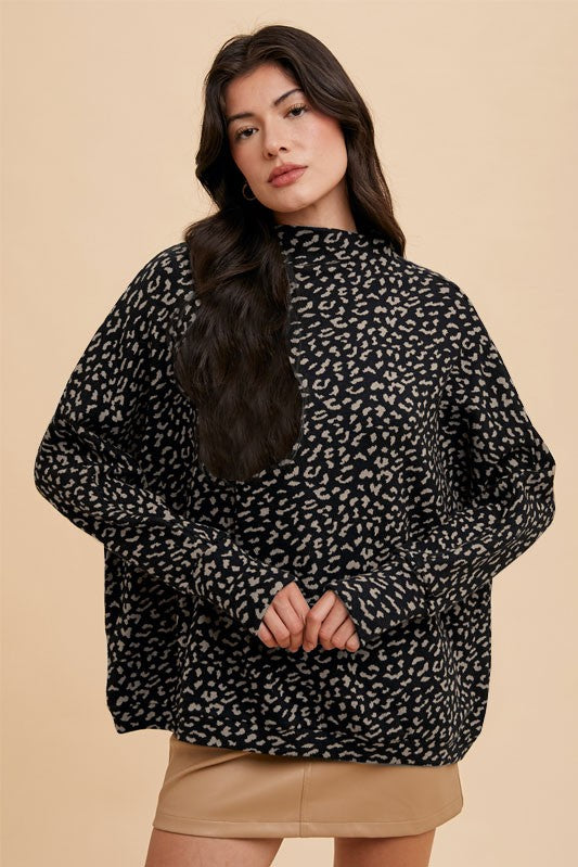 Woman wearing Kaida Leopard Sweater with animal jacquard knit, mock-neck, and relaxed fit for a chic, versatile look.