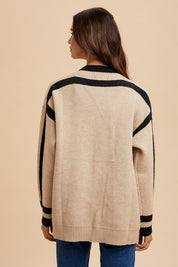 Woman wearing Elowen Sweater Jacket with contrast line details and patch pockets, showcasing back view and relaxed fit.