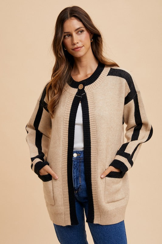 Woman wearing Elowen Sweater Jacket with patch pockets and contrast line details, styled with jeans and a white top.