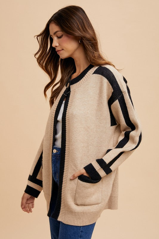 Woman wearing Elowen Sweater Jacket with open-front design and contrast line details, showcasing a casual and elegant style.