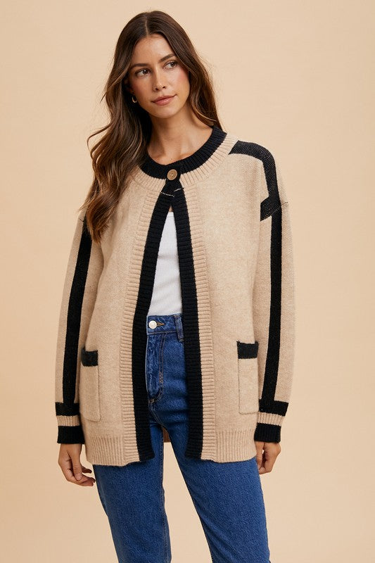 Woman wearing Elowen Sweater Jacket with open-front design and patch pockets, styled with jeans for cozy elegance.