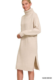 Woman wearing sand beige sable turtleneck sweater dress with long sleeves and side slit, showcasing cozy knit elegance.