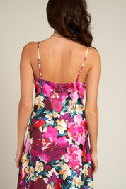 Back view of the Tessa Floral Satin Dress showcasing vibrant floral design and delicate straps.