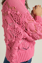 Side view of a pink Scarlette Crochet Sweater showcasing intricate crochet design and button details.