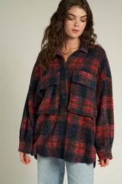 Woman wearing an oversized Indie Plaid Shacket in red and navy plaid, showcasing its relaxed fit and cozy design.