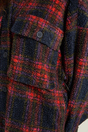 Close-up of the Indie Plaid Shacket featuring a fuzzy plaid pattern in red and navy, with pocket and button details.