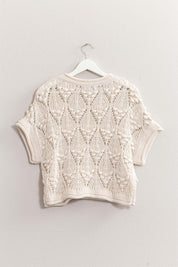 Kate Knit TopThe Kate Knit Top is a perfect blend of style and comfort. This crochet knit short sleeve top features an intricate crochet pattern that adds a touch of vintage charm. The short sleeves and lightweight fabric make it ideal for warm weather, w