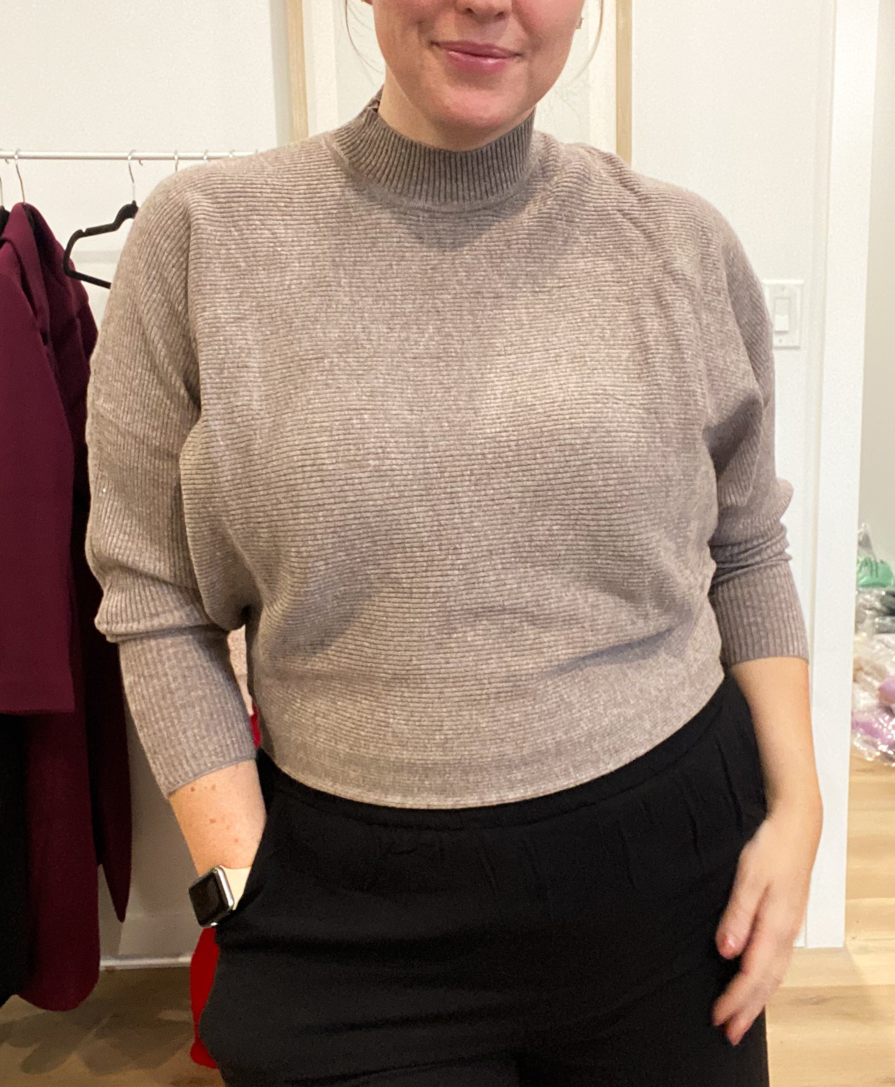 Woman wearing Celeste Cozy Pullover, a rib-knit sweater with dolman sleeves and a mock neck, styled casually.