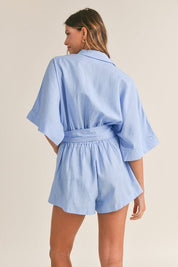 Cali Button Front RomperIntroducing our Cali Solid Button Down Collared Romper, the versatile piece your summer wardrobe has been craving! Crafted with comfort and style in mind, this romper features short sleeves, a classic button-down front, and a sophi