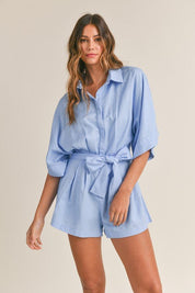 Cali Button Front RomperIntroducing our Cali Solid Button Down Collared Romper, the versatile piece your summer wardrobe has been craving! Crafted with comfort and style in mind, this romper features short sleeves, a classic button-down front, and a sophi