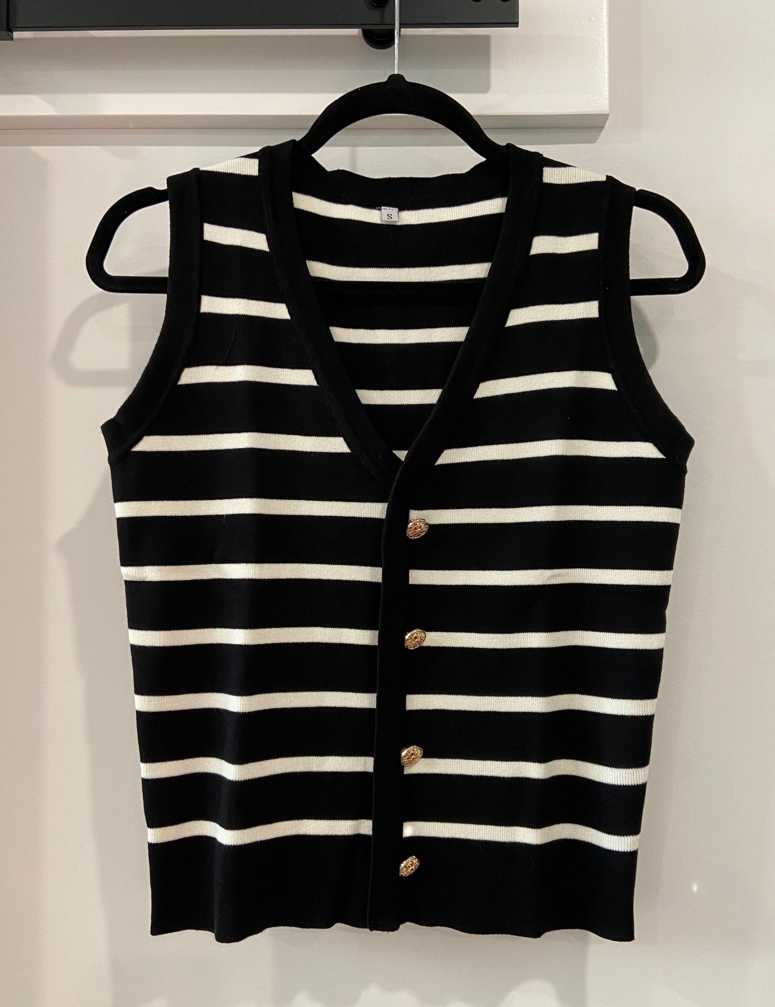 Cleo Stripe Knit VestEnhance your wardrobe with the Cleo Stripe Vest, a versatile sleeveless V-neck contrasting cardigan for women that effortlessly elevates your ensemble. This stylish piece features a flattering V-neck design and contrasting stripes tha