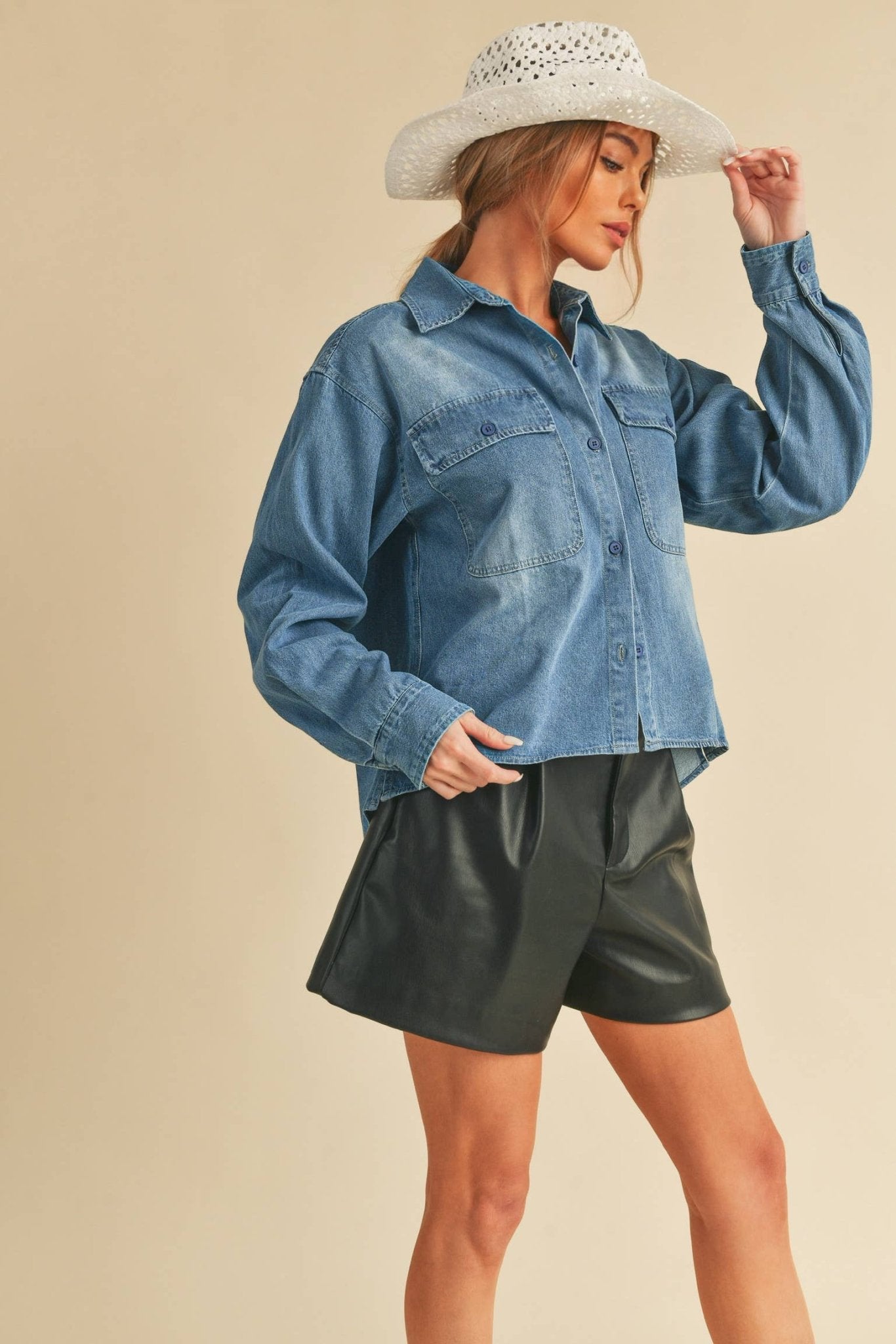 Genny Denim TopRevamp your style with this Genny faded denim shirt. Featuring button closure, spread collar, and long sleeves with button cuffs. The high-low hem adds a touch of edge, while the button-close chest pockets offer functionality and flair. Ele