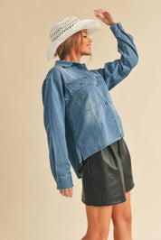 Genny Denim TopRevamp your style with this Genny faded denim shirt. Featuring button closure, spread collar, and long sleeves with button cuffs. The high-low hem adds a touch of edge, while the button-close chest pockets offer functionality and flair. Ele