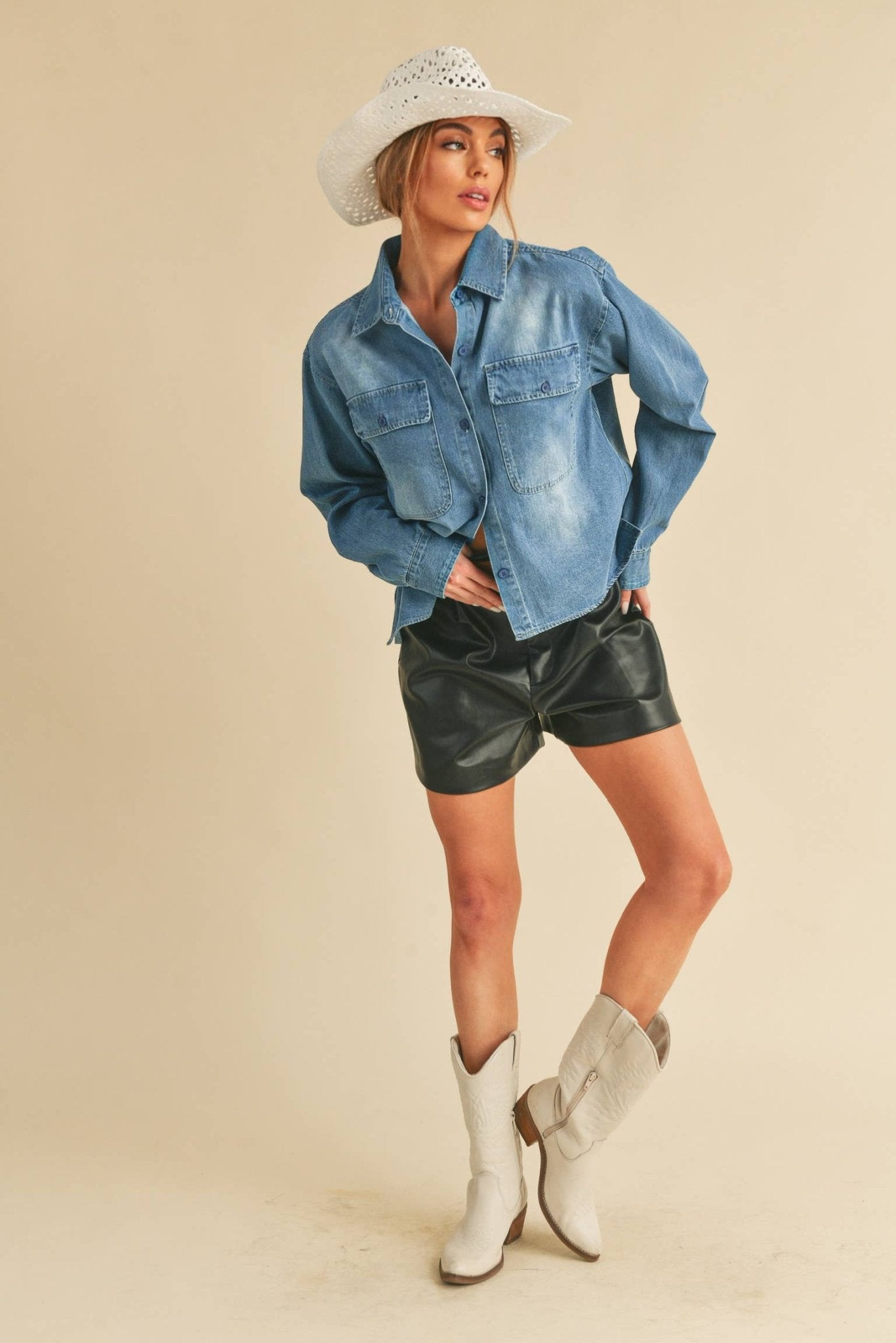 Genny Denim TopRevamp your style with this Genny faded denim shirt. Featuring button closure, spread collar, and long sleeves with button cuffs. The high-low hem adds a touch of edge, while the button-close chest pockets offer functionality and flair. Ele