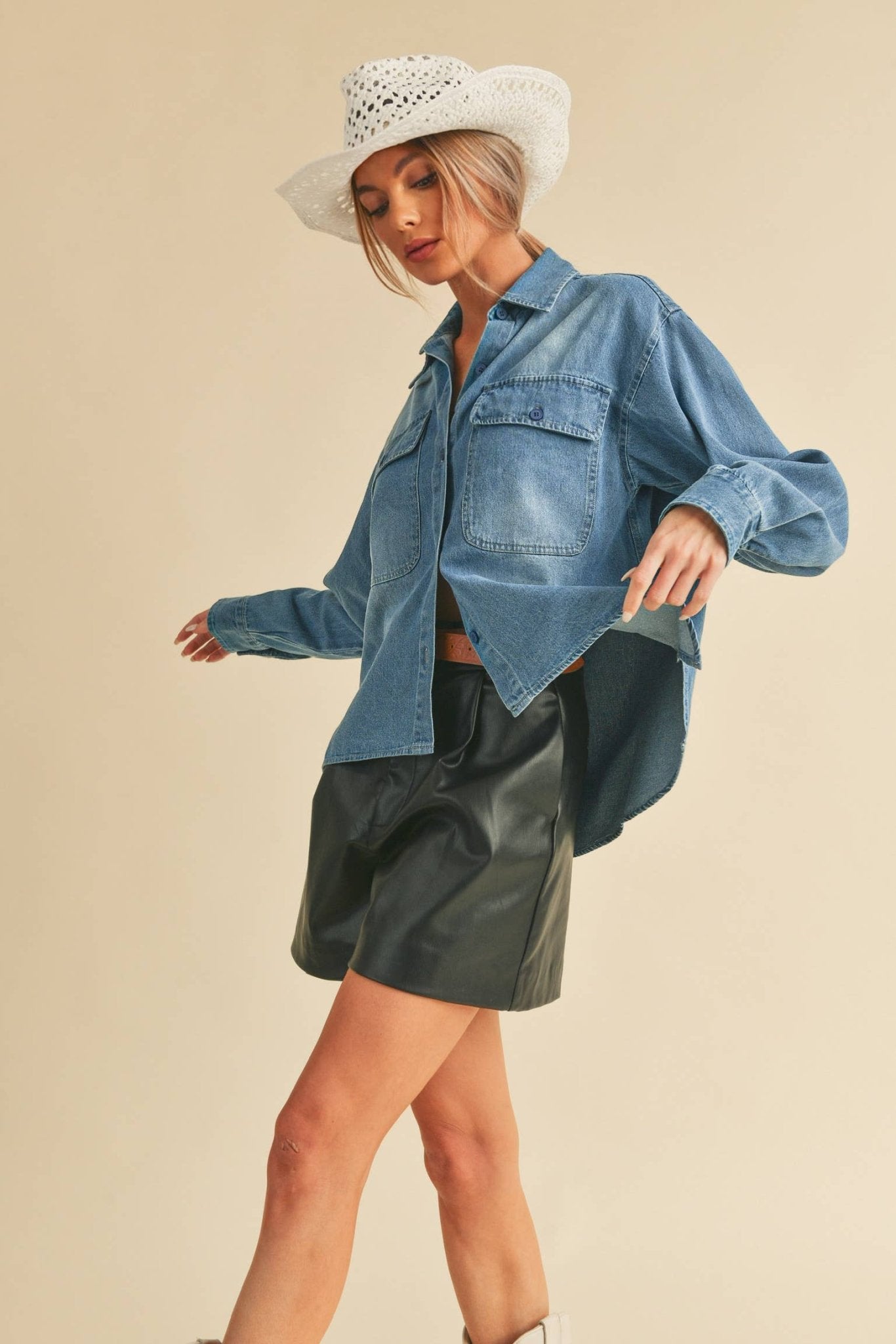 Genny Denim TopRevamp your style with this Genny faded denim shirt. Featuring button closure, spread collar, and long sleeves with button cuffs. The high-low hem adds a touch of edge, while the button-close chest pockets offer functionality and flair. Ele