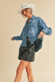 Genny Denim TopRevamp your style with this Genny faded denim shirt. Featuring button closure, spread collar, and long sleeves with button cuffs. The high-low hem adds a touch of edge, while the button-close chest pockets offer functionality and flair. Ele