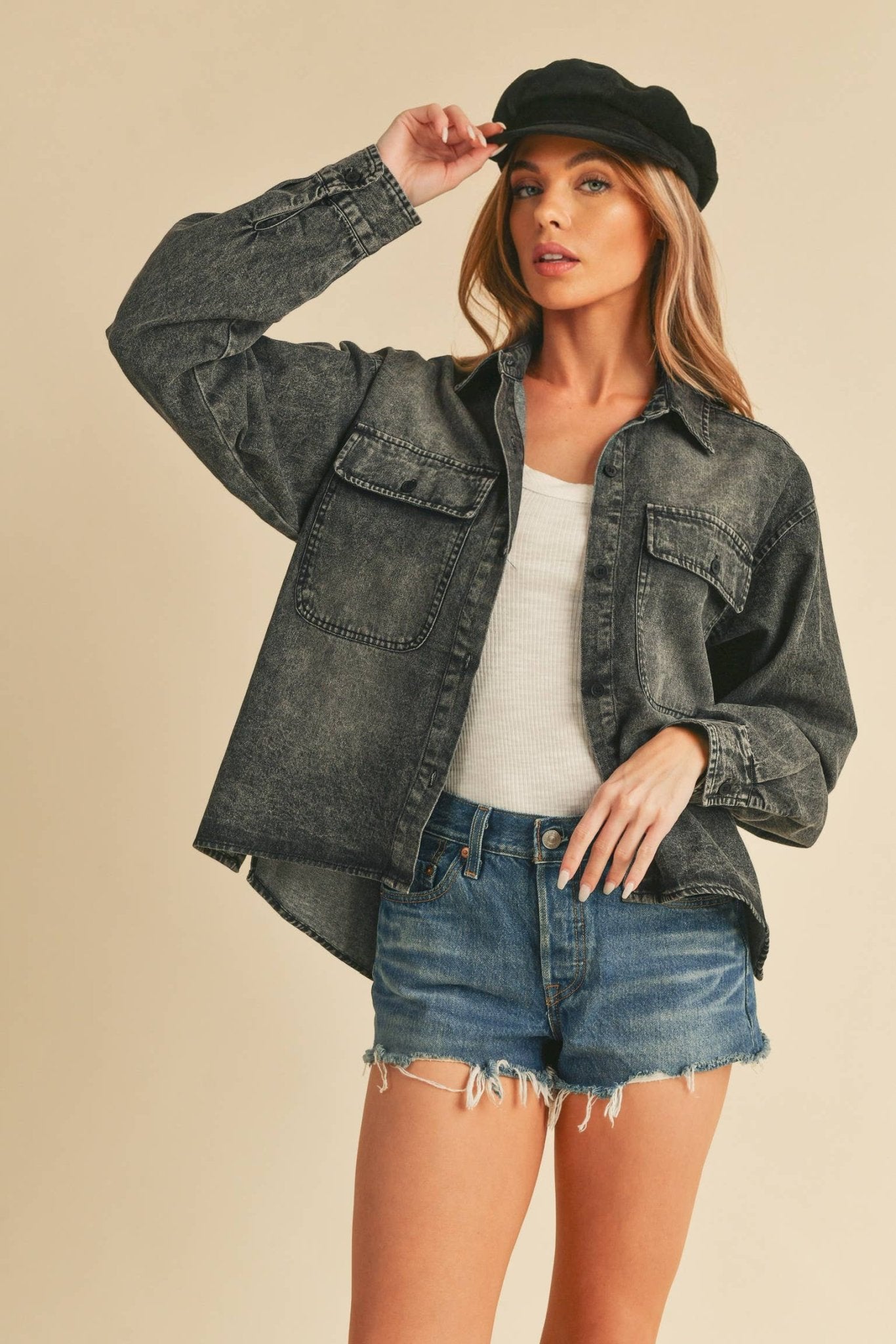 Genny Denim TopRevamp your style with this Genny faded denim shirt. Featuring button closure, spread collar, and long sleeves with button cuffs. The high-low hem adds a touch of edge, while the button-close chest pockets offer functionality and flair. Ele