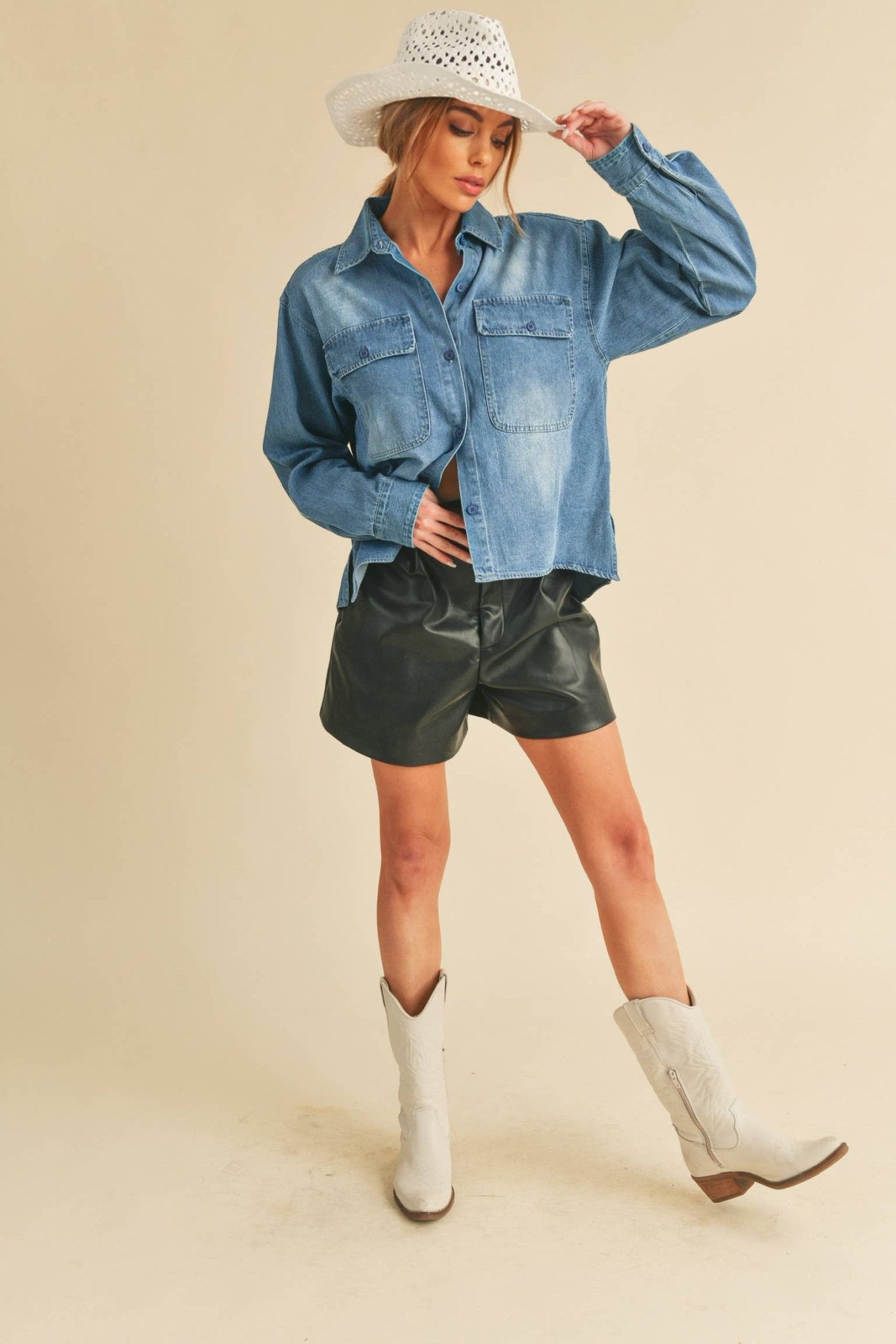 Genny Denim TopRevamp your style with this Genny faded denim shirt. Featuring button closure, spread collar, and long sleeves with button cuffs. The high-low hem adds a touch of edge, while the button-close chest pockets offer functionality and flair. Ele