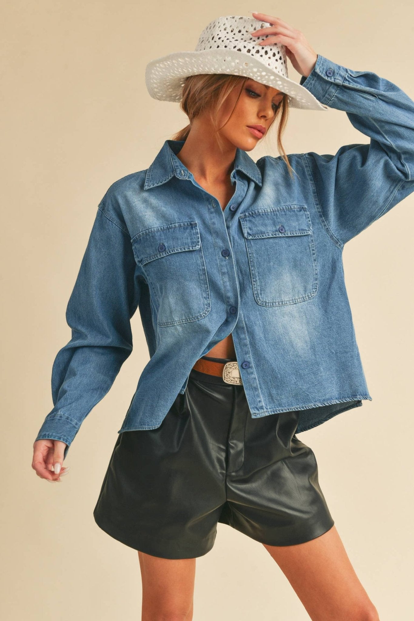 Genny Denim TopRevamp your style with this Genny faded denim shirt. Featuring button closure, spread collar, and long sleeves with button cuffs. The high-low hem adds a touch of edge, while the button-close chest pockets offer functionality and flair. Ele