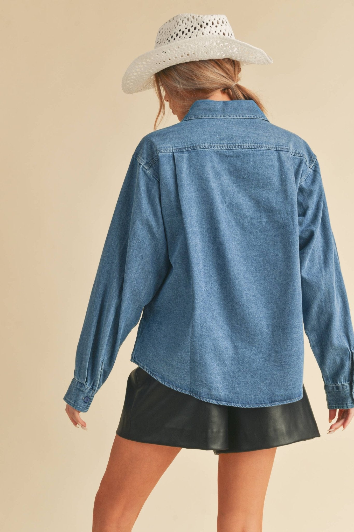 Genny Denim TopRevamp your style with this Genny faded denim shirt. Featuring button closure, spread collar, and long sleeves with button cuffs. The high-low hem adds a touch of edge, while the button-close chest pockets offer functionality and flair. Ele