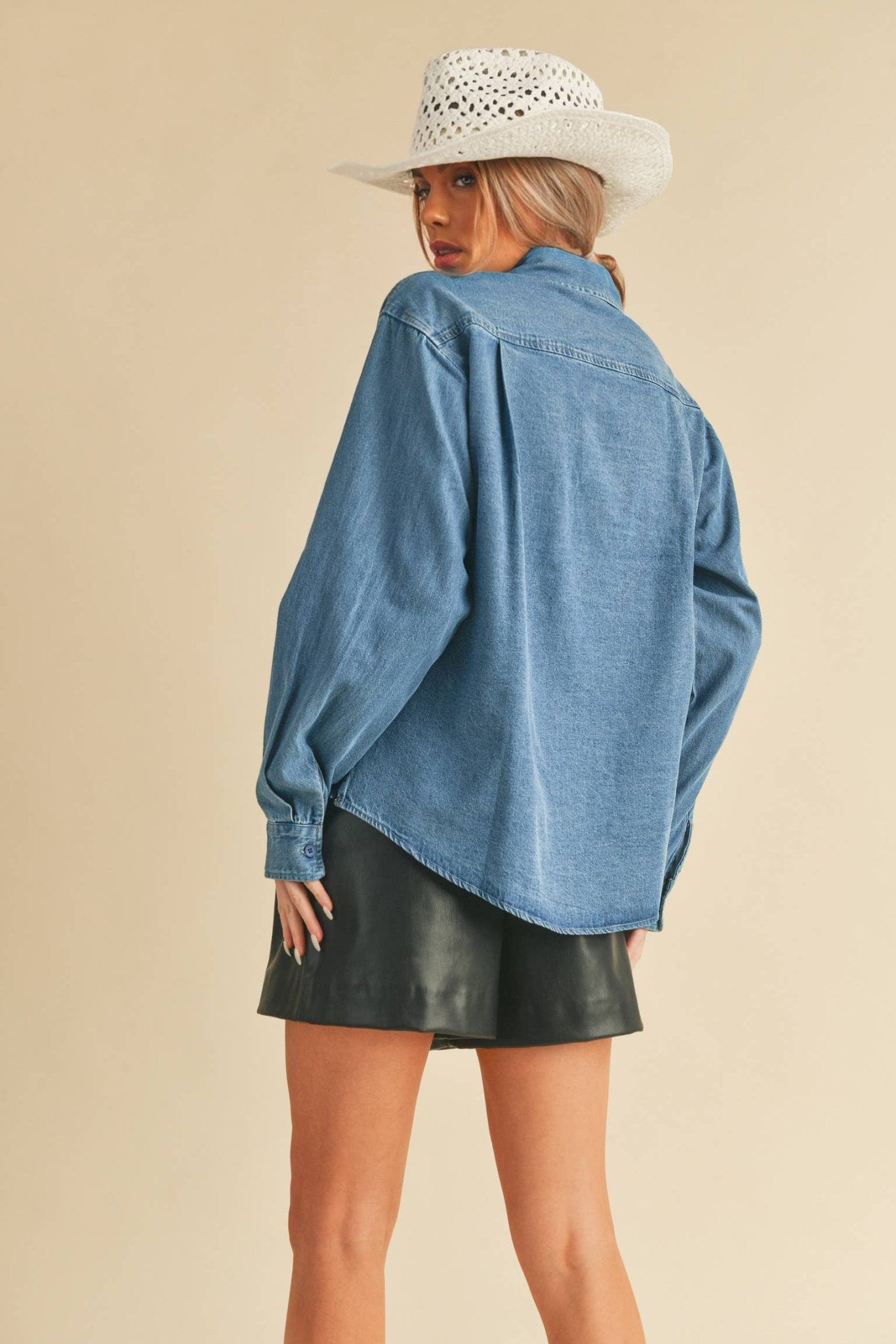 Genny Denim TopRevamp your style with this Genny faded denim shirt. Featuring button closure, spread collar, and long sleeves with button cuffs. The high-low hem adds a touch of edge, while the button-close chest pockets offer functionality and flair. Ele