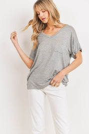 Jersey Pocket TeeCrafted from high-quality knit jersey fabric, these tops offer both comfort and style. Featuring a V-neck design, drop shoulder, and single chest pocket, each piece exudes effortless elegance. The cuffed and tacked short sleeves add a tou