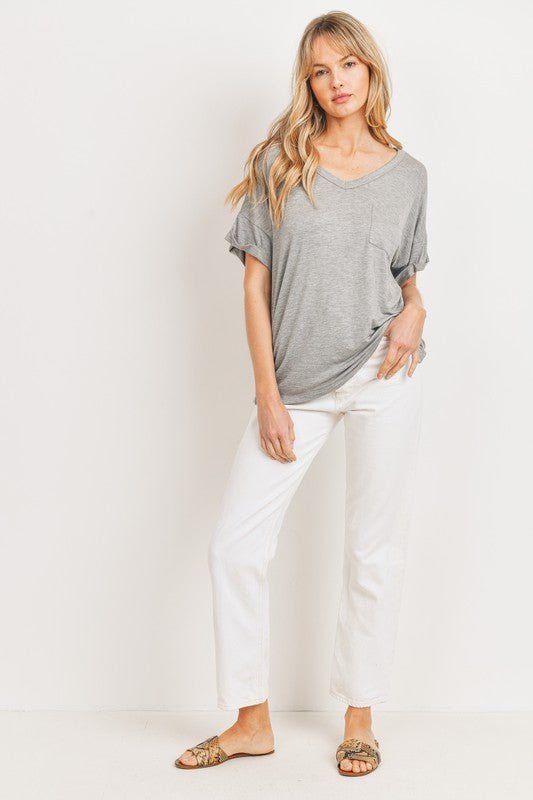 Jersey Pocket TeeCrafted from high-quality knit jersey fabric, these tops offer both comfort and style. Featuring a V-neck design, drop shoulder, and single chest pocket, each piece exudes effortless elegance. The cuffed and tacked short sleeves add a tou