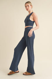 Jet Stream Lounge SetWelcome the Jet Stream Lounge Set! The Long-Length Wide Leg Pants feature a sleek and sophisticated design crafted from a soft and breathable fabric. With their elongating silhouette and wide-leg cut, these pants offer a flattering fi