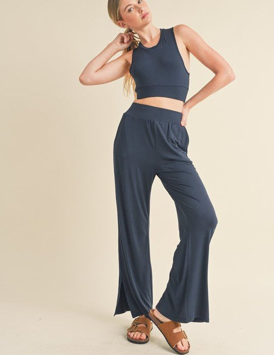 Jet Stream Lounge SetWelcome the Jet Stream Lounge Set! The Long-Length Wide Leg Pants feature a sleek and sophisticated design crafted from a soft and breathable fabric. With their elongating silhouette and wide-leg cut, these pants offer a flattering fi