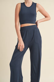 Jet Stream Lounge SetWelcome the Jet Stream Lounge Set! The Long-Length Wide Leg Pants feature a sleek and sophisticated design crafted from a soft and breathable fabric. With their elongating silhouette and wide-leg cut, these pants offer a flattering fi