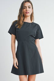 Luella Tie Back Mini DressThe Tie Back Mini Dress is a chic and versatile wardrobe staple that effortlessly combines style and comfort. This fashionable dress features a flattering mini length, showcasing your legs while providing a trendy look. The defin